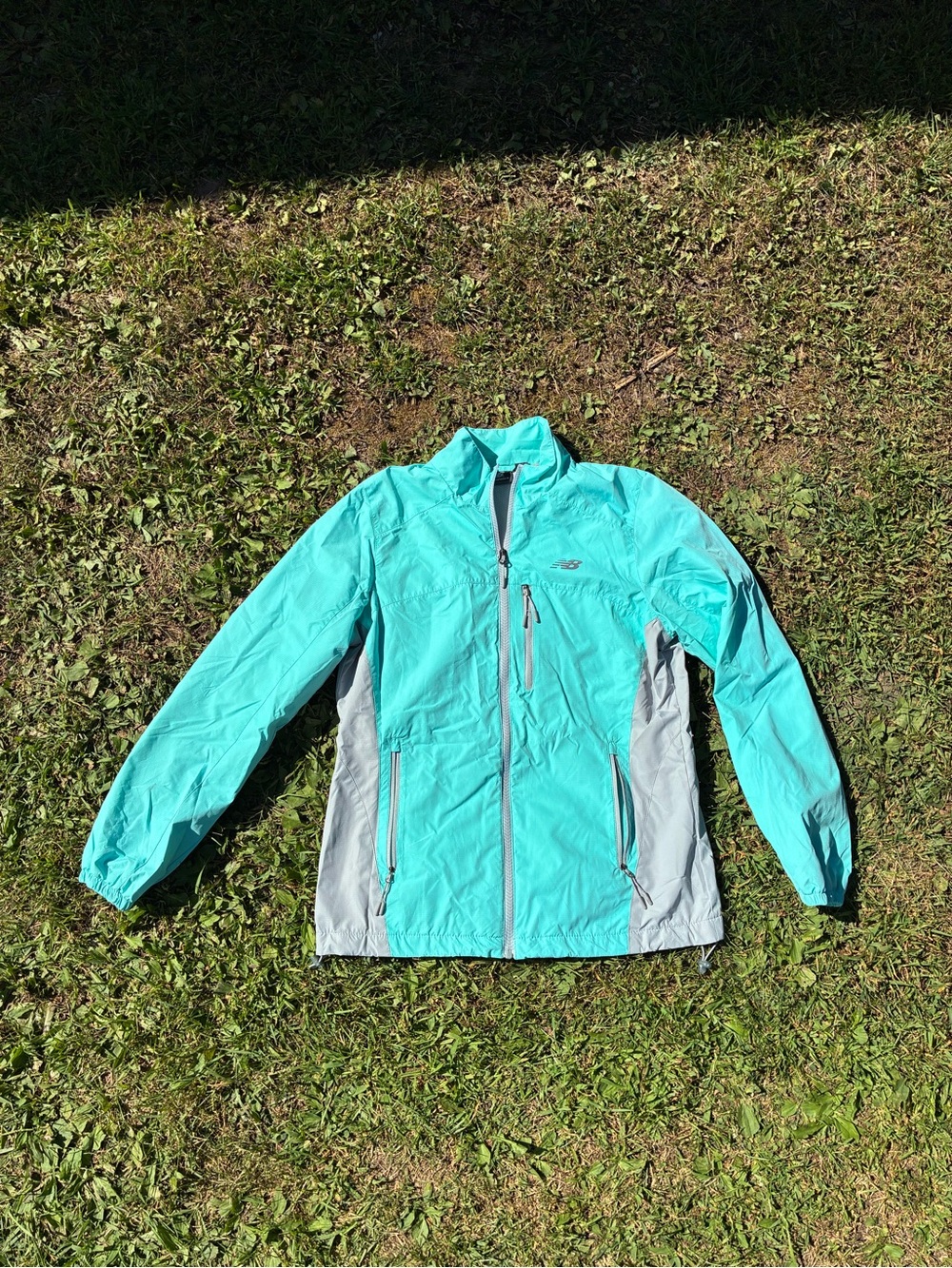 Woman’s New Balance teal blue wind breaker light jacket